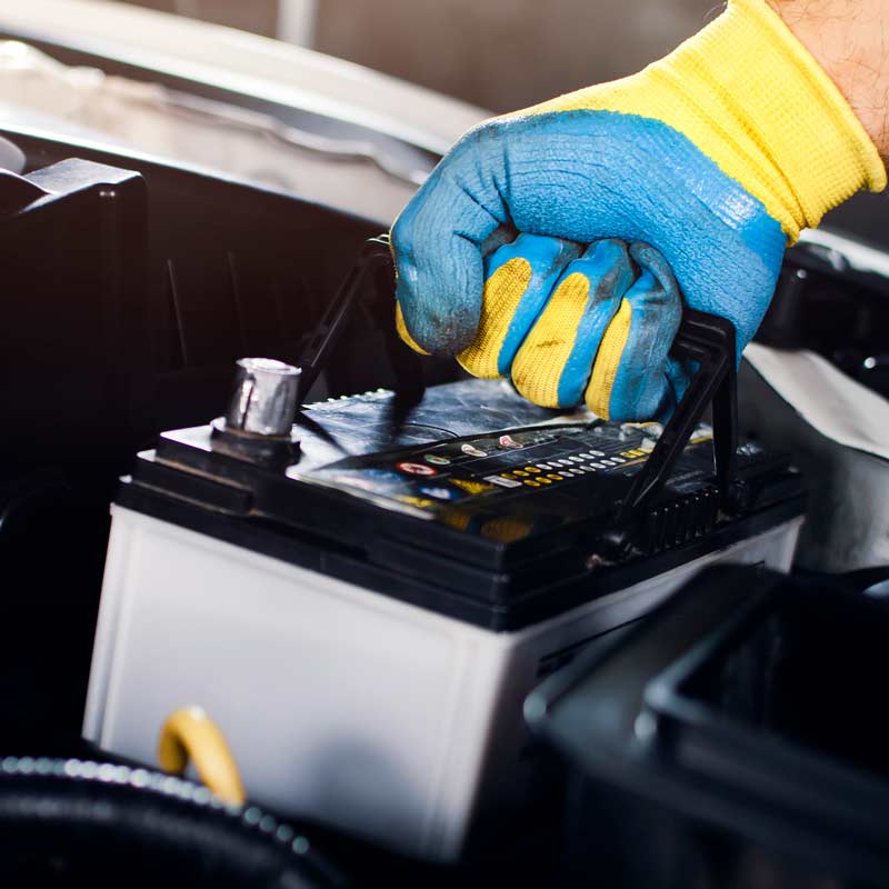 Engineer removing a lead acid battery